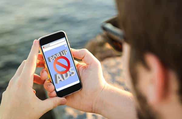 Intrusive advertising mobile blocker man on beach
