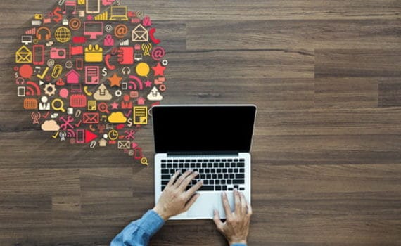 Man typing on laptop with icons