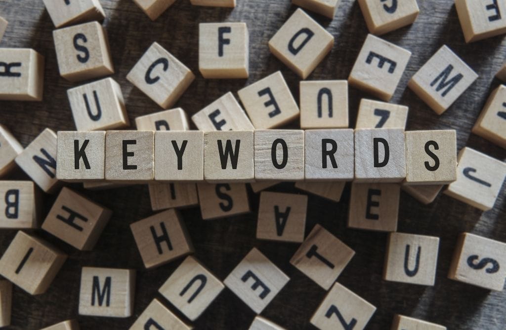 square blocks with letters on spelling out the word 'keywords' with other blocks in the background