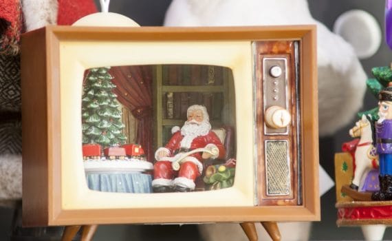 A toy Santa sat in a toy 80s style telly