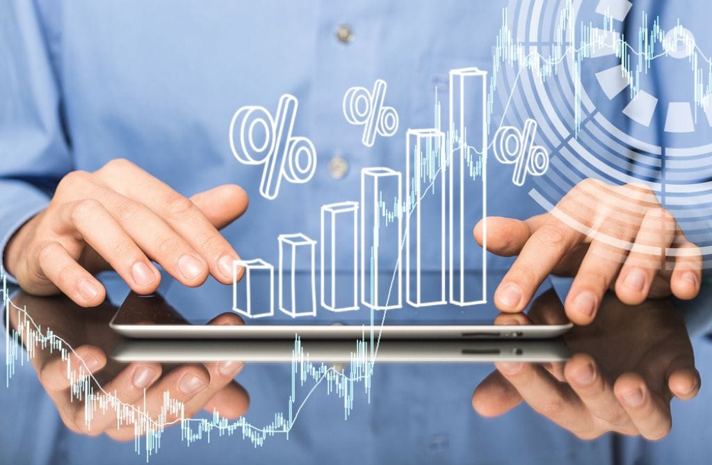 A professional uses an iPad with a percentages bar chart hovering over it