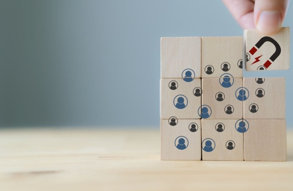 a stylised depiction of a magnet attracting customers