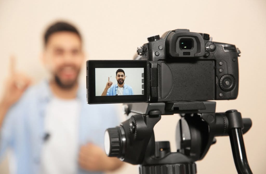 A man filming SEO content on a camera