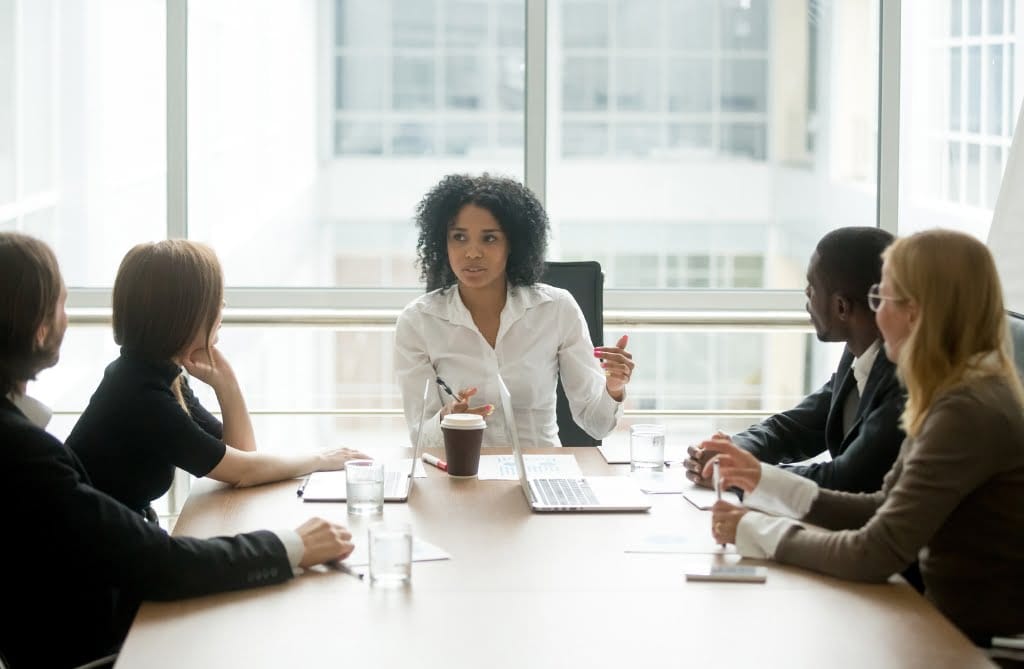 A female marketing manager leading a marketing meeting
