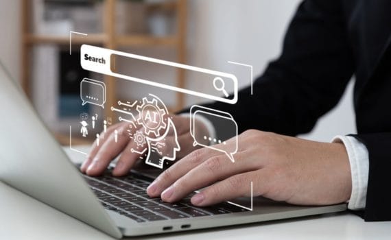 A stylised image of someone using a laptop to search with AI