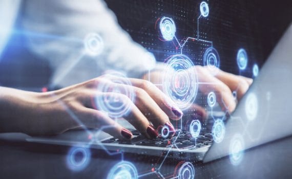 a stylised image of hands using a laptop symbolising copywriting with AI