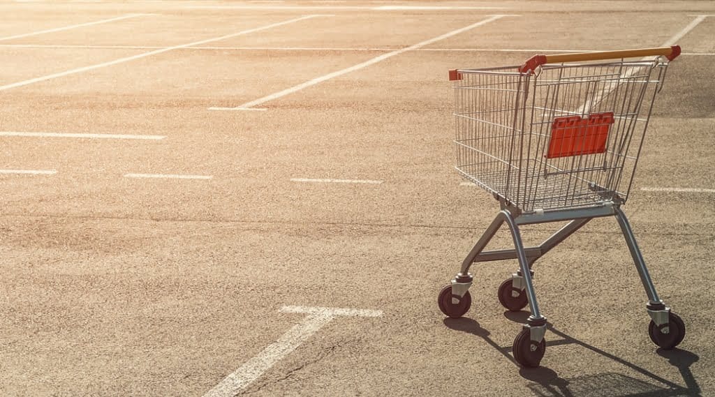 an abandoned shopping trolley/cart in a car park