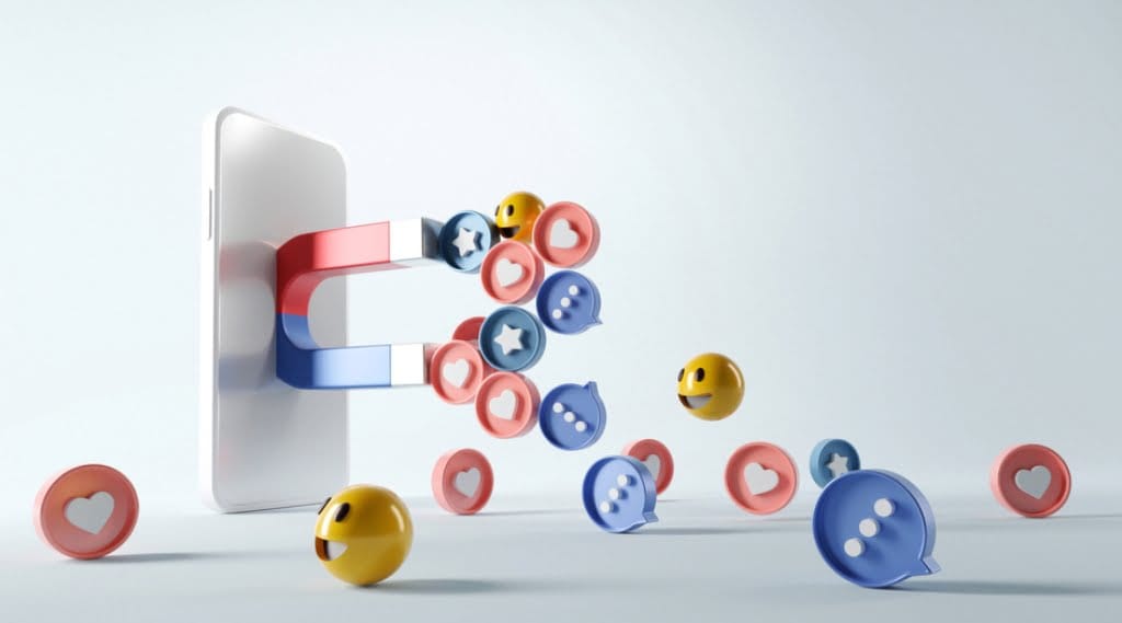 A phone with a magnet attached attracts social media icons