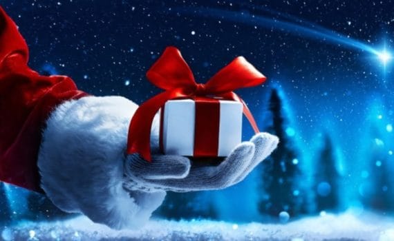 A festive, santa-esque hand holding a gift