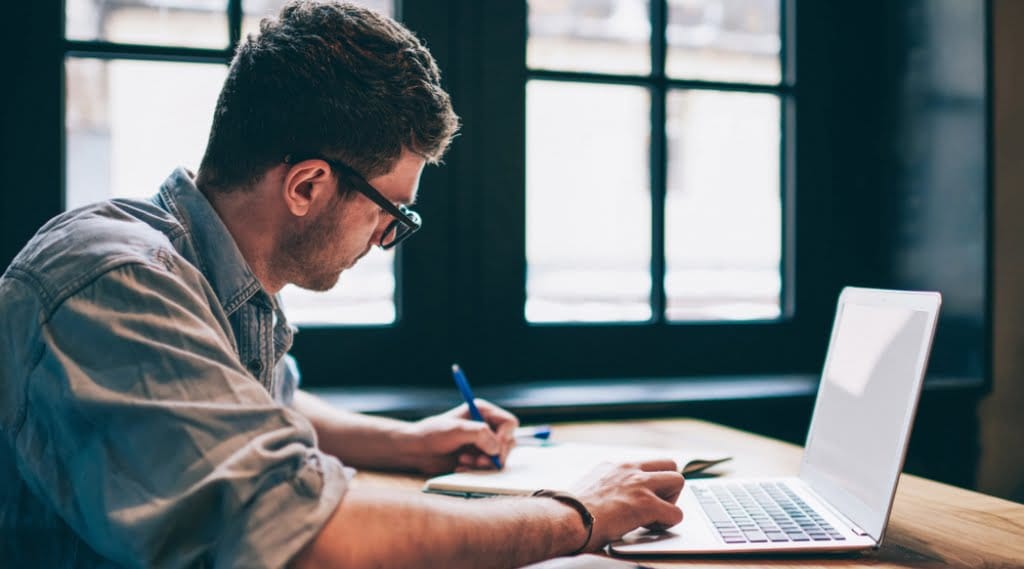 someone develops high quality SEO content on a laptop and notebook