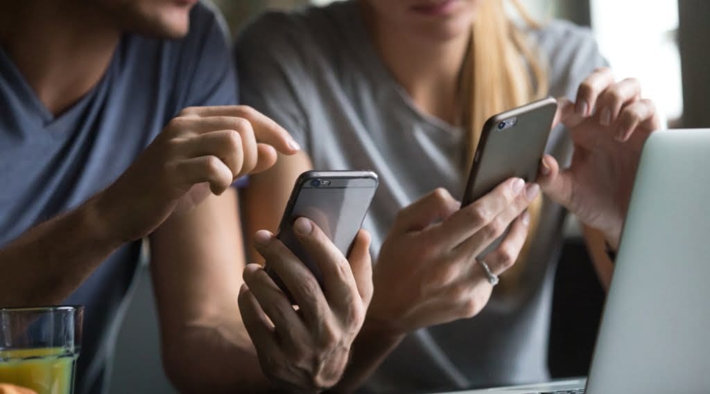 Two women using smartphones to access quality SEO content