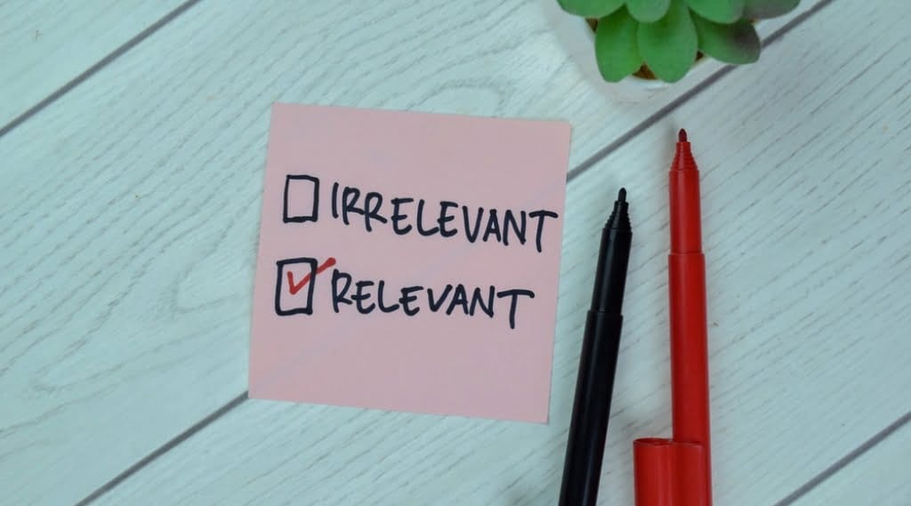 A post it note with two tick boxes next to the words 'irrelevant' and 'relevant.' Relevant is ticked.