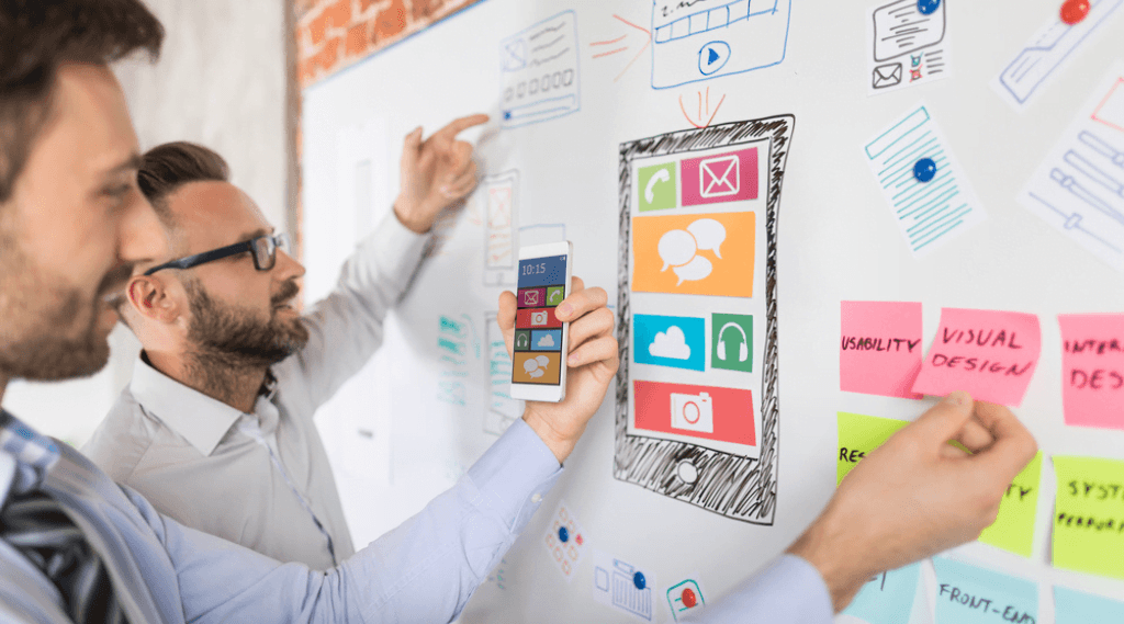 Two people designing to best optimise SEO capabilities.