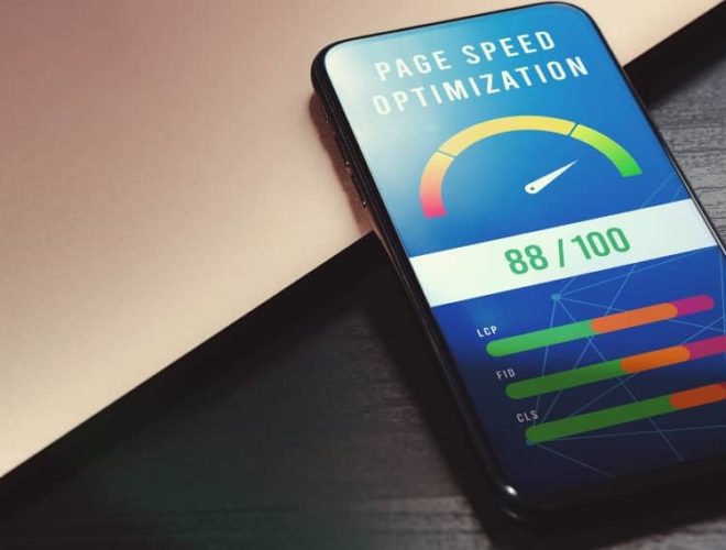 Smartphone showing 88/100 score for 7-second site speed test optimisation on a desk beside a laptop.
