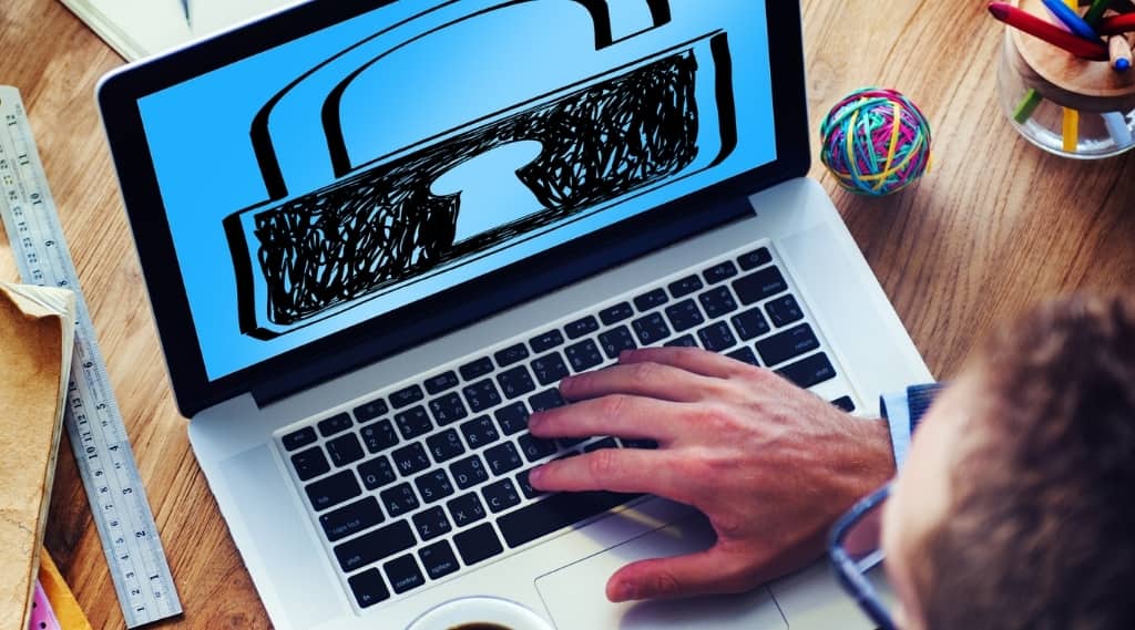 Person using laptop with a padlock image on screen for security