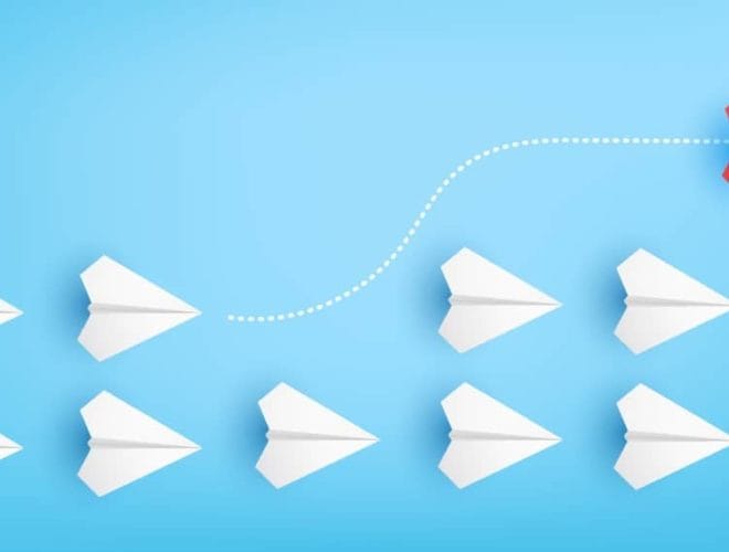 Illustration of red paper plane changing direction from white paper planes