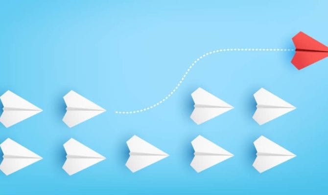 Illustration of red paper plane changing direction from white paper planes