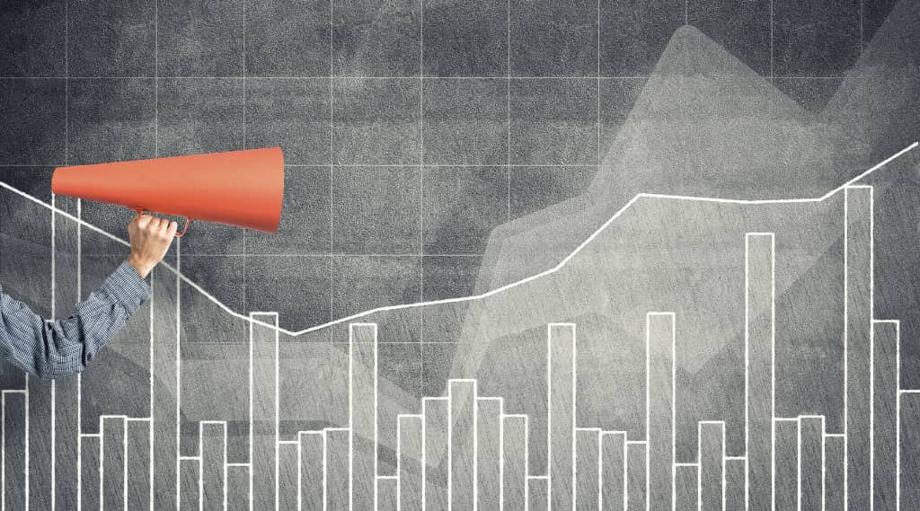 Person holding megaphone in front of growth chart, representing measuring and reviewing SEO package success.