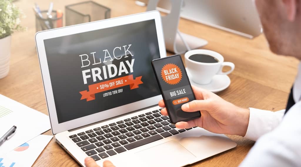 Laptop and smartphone screen showing Black Friday Ads for Google Ads Hampshire promotions.