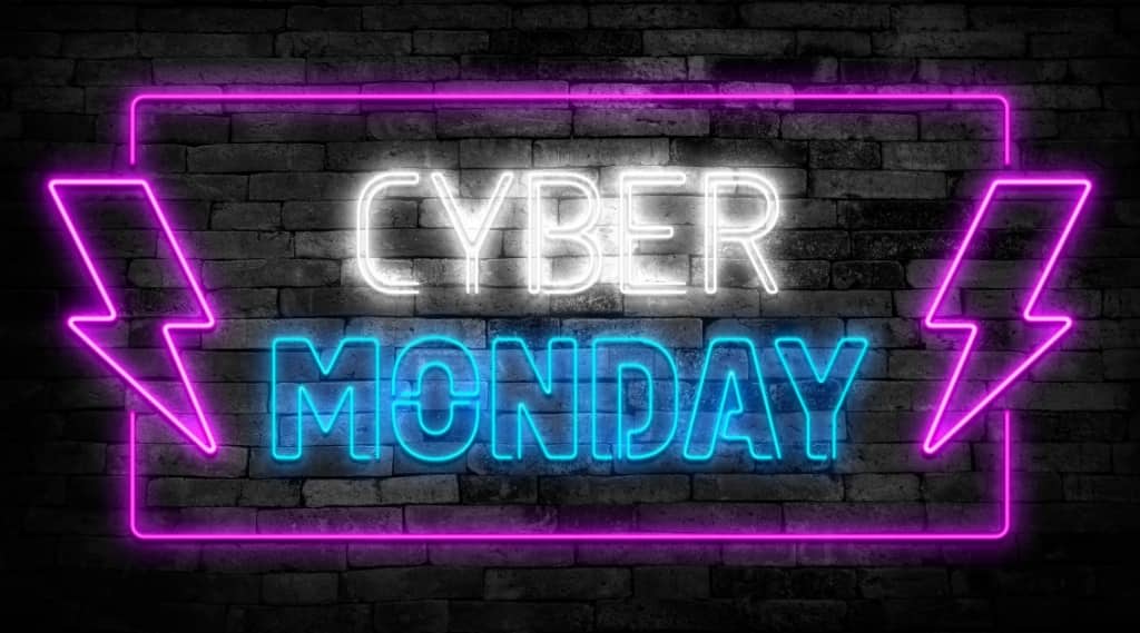 Neon sign displaying Cyber Monday Ads promotion with bright purple and blue lights.