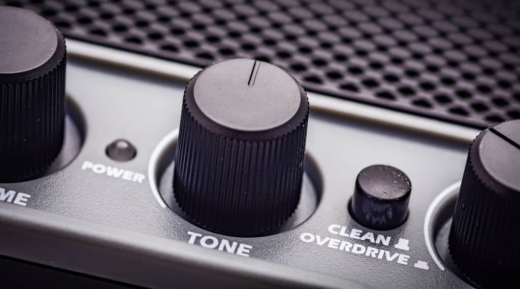 Close-up of amplifier tone control knob, representing tone of voice, addressing customer pain points and improving website copy through writing blogs.
