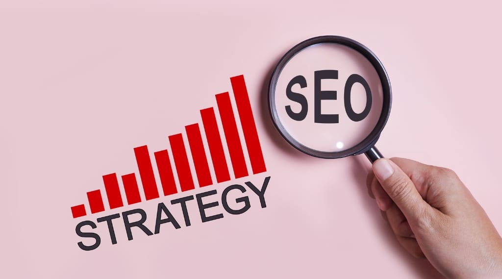 Search engine marketing: A magnifying glass highlighting the letters SEO next to a rising strategy bar chart on a pink background.