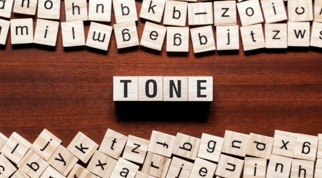 call to action tone best practice, wooden letter tiles scattered on a table with the word TONE spelled out in the centre