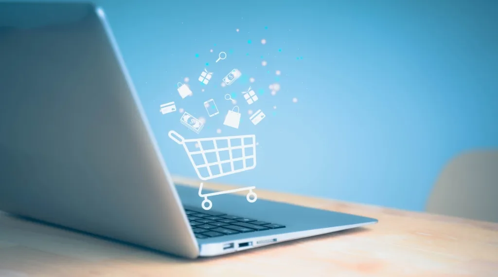 retail media digital marketing trend, a laptop with a glowing shopping trolley icon above it surrounded by digital shopping symbols