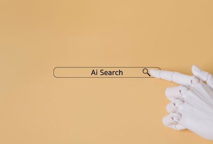 what is answer engine optimisation, a robotic hand pressing a search bar labelled Ai Search on a beige background