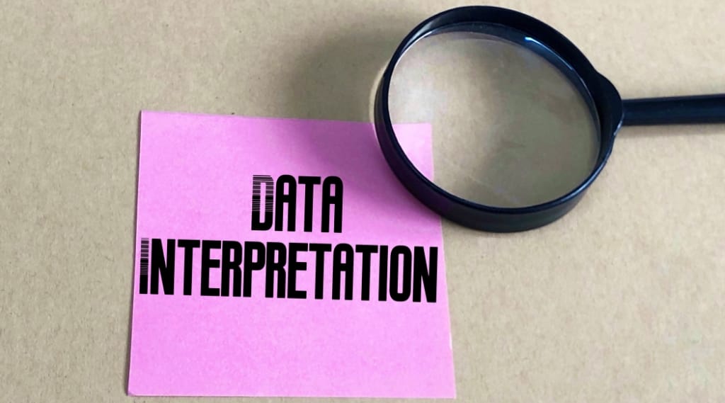 Data-driven marketing strategy: Pink sticky note reading data interpretation with a magnifying glass, symbolising data-driven marketing strategy and analysis.