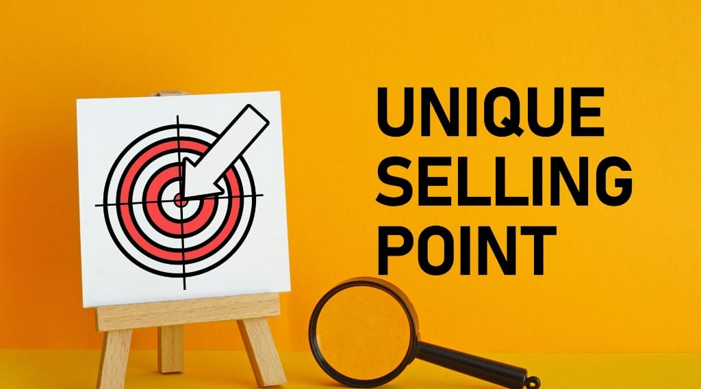 Cutting marketing budget: target board with arrow hitting the centre next to the words unique selling point.