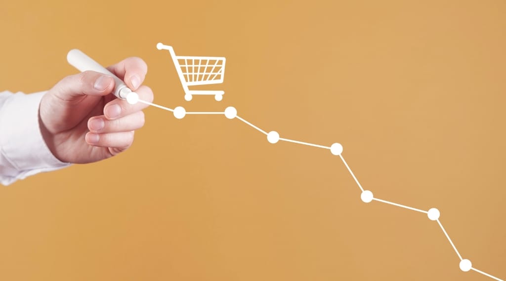 Cutting marketing budget is bad: downward sloping line graph with shopping cart icon symbolising falling revenue.