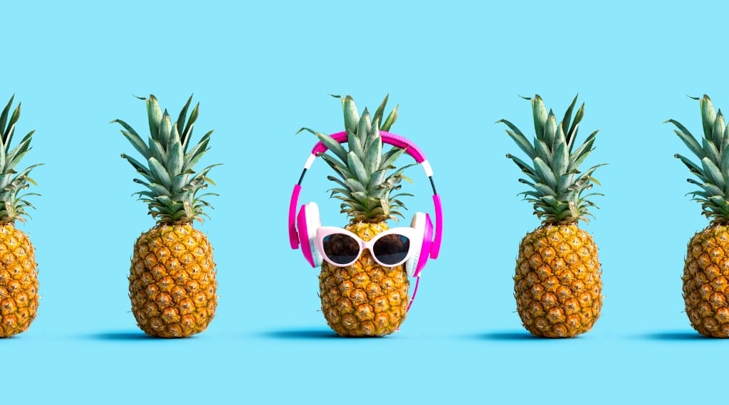 Brand exposure frequency: Pineapple wearing headphones and sunglasses among identical pineapples representing repeated brand exposure