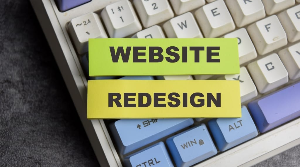 When to redesign a website "Two sticky notes reading 'Website Redesign' placed on a computer keyboard"
