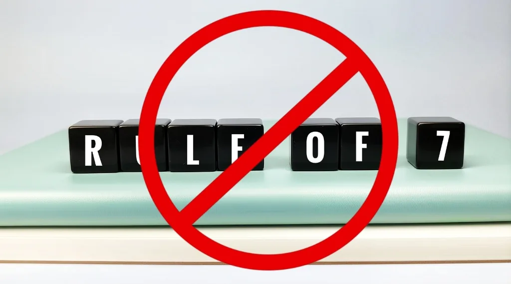 Marketing rule of 7: Black blocks spelling rule of 7 crossed out with red prohibition symbol representing outdated marketing theory