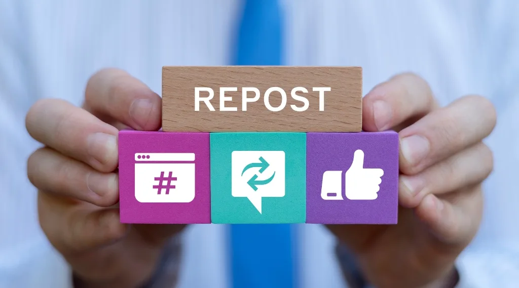 New vs old content "Hands holding three colourful wooden blocks displaying a hashtag icon, a repost symbol, and a thumbs up icon, with a 'Repost' label on top"