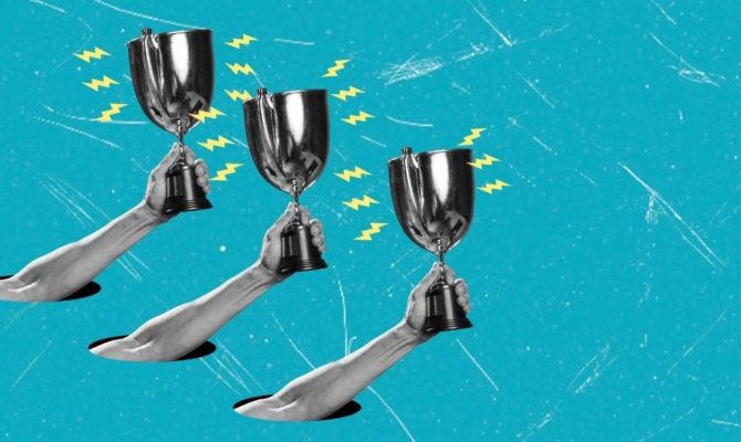 Web Excellence Awards 2026: Three black-and-white arms reach up through holes in a bright turquoise background, each raising a silver trophy cup surrounded by yellow lightning bolts.