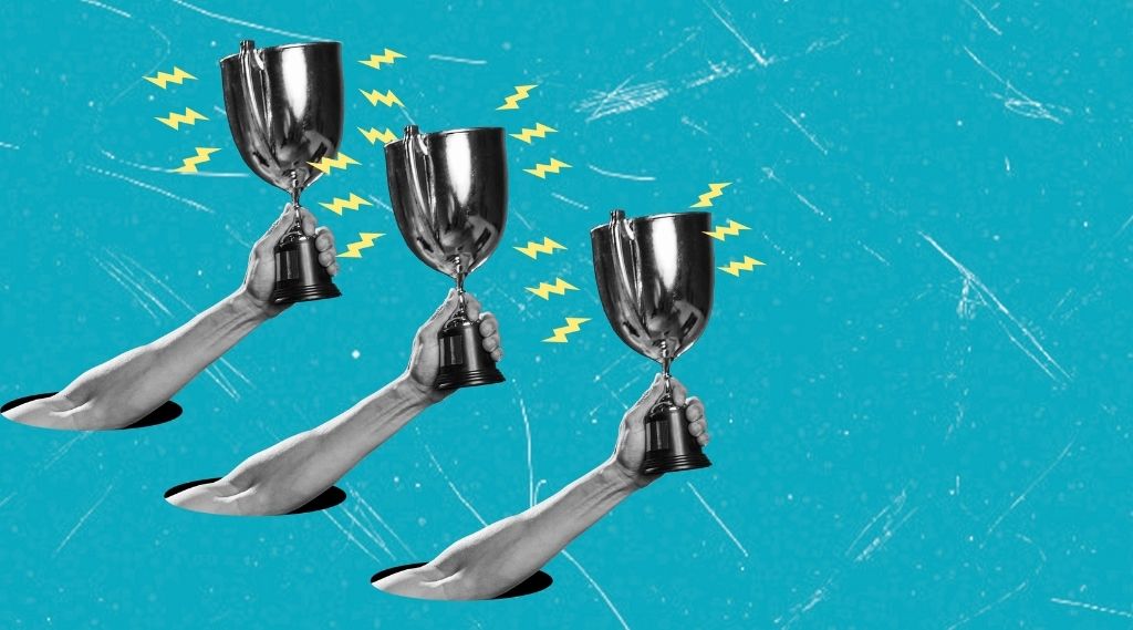 Web Excellence Awards 2026: Three black-and-white arms reach up through holes in a bright turquoise background, each raising a silver trophy cup surrounded by yellow lightning bolts.