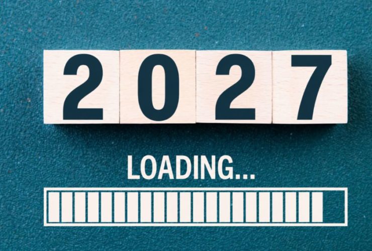 how much should I spend on marketing in 2027: Four wooden blocks spelling “2027” on a teal surface, above the word "Loading..." and a nearly full white loading bar.