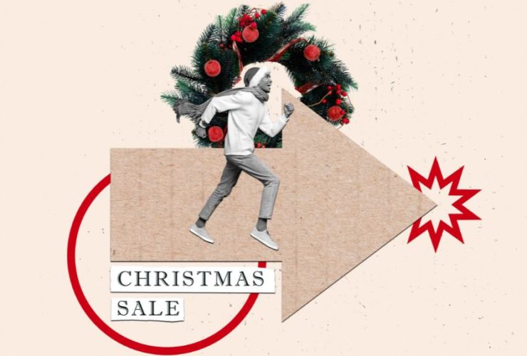 when do Christmas shoppers start researching: A collage of a smiling man in a bobble hat, scarf and jumper running along a large cardboard arrow, in front of a Christmas wreath with red baubles. Text cut-outs below read “Christmas Sale”, next to a red starburst and a red circle.